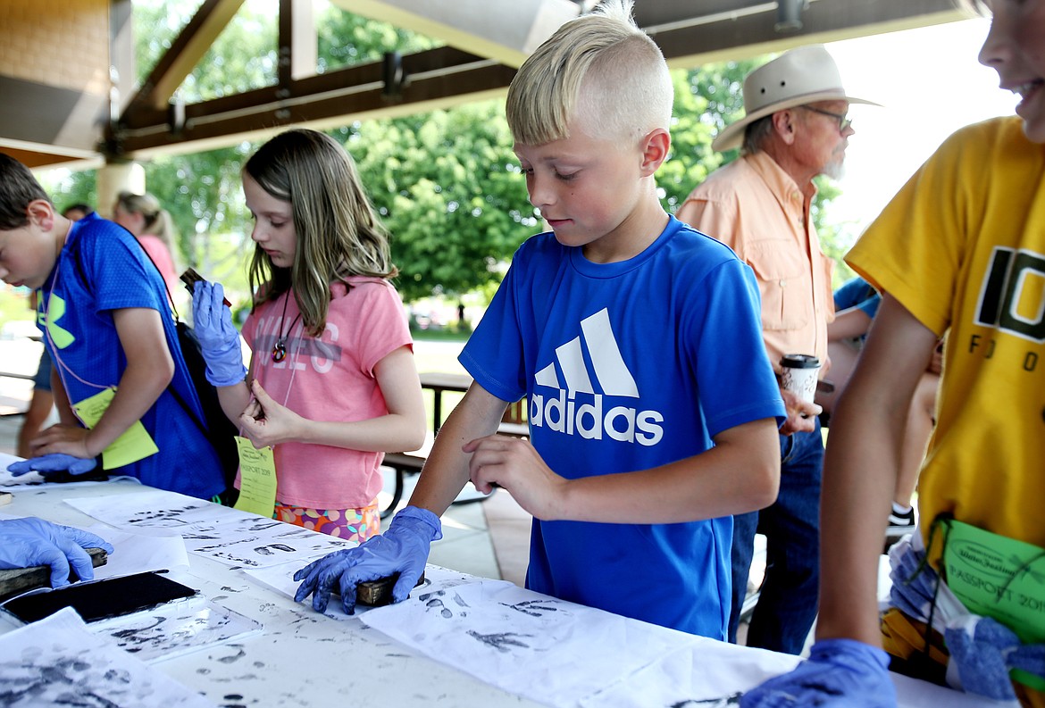 Skyway Elementary School fifth-grader Keegan Wilson presses a bobcat print onto a bandana at Thursday&#146;s Water Festival at McEuen Park.