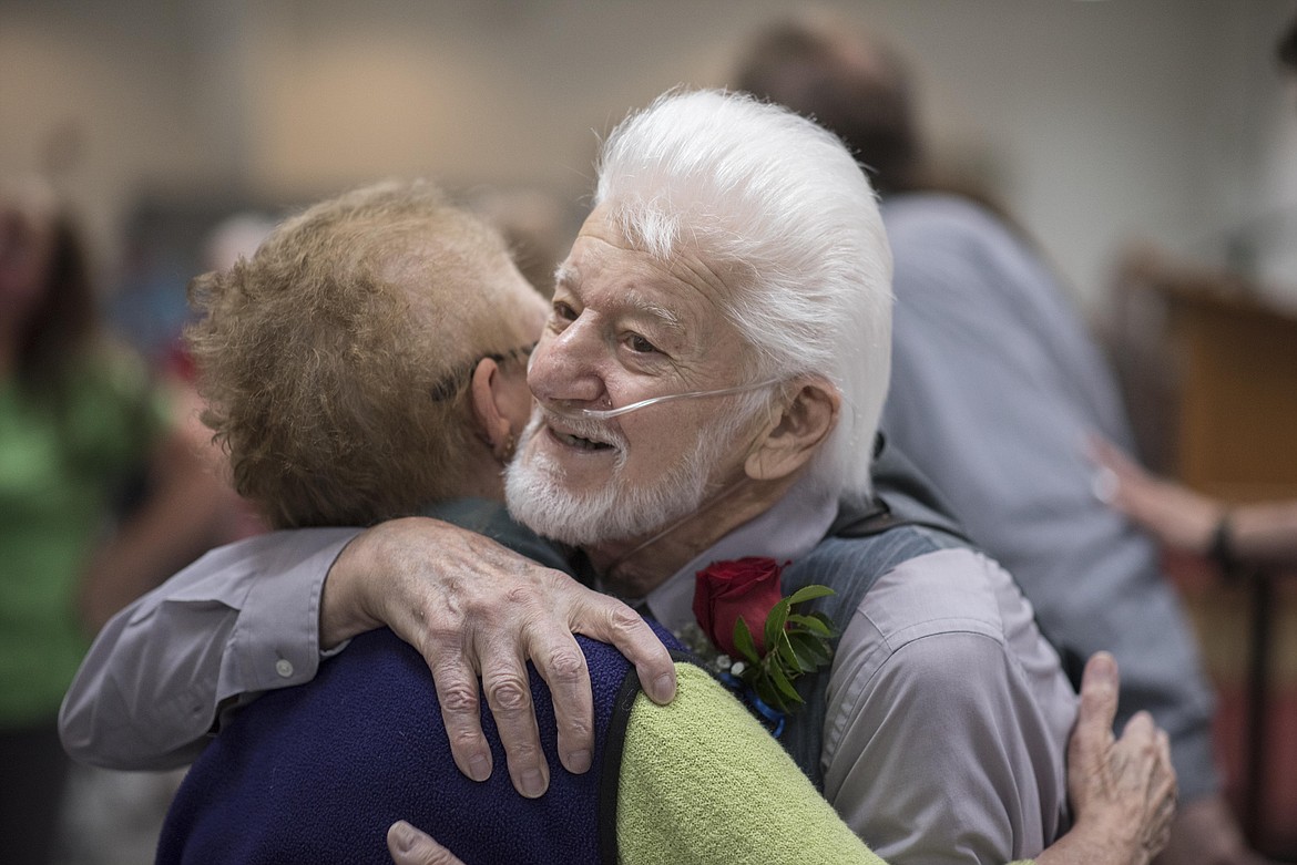 Veteran John Alex is embraced by award ceremony attendees after receiving the Montana Congressional Veteran Commendation, Friday at the Libby Veterans of Foreign Wars Post 1548. (Luke Hollister/The Western News)