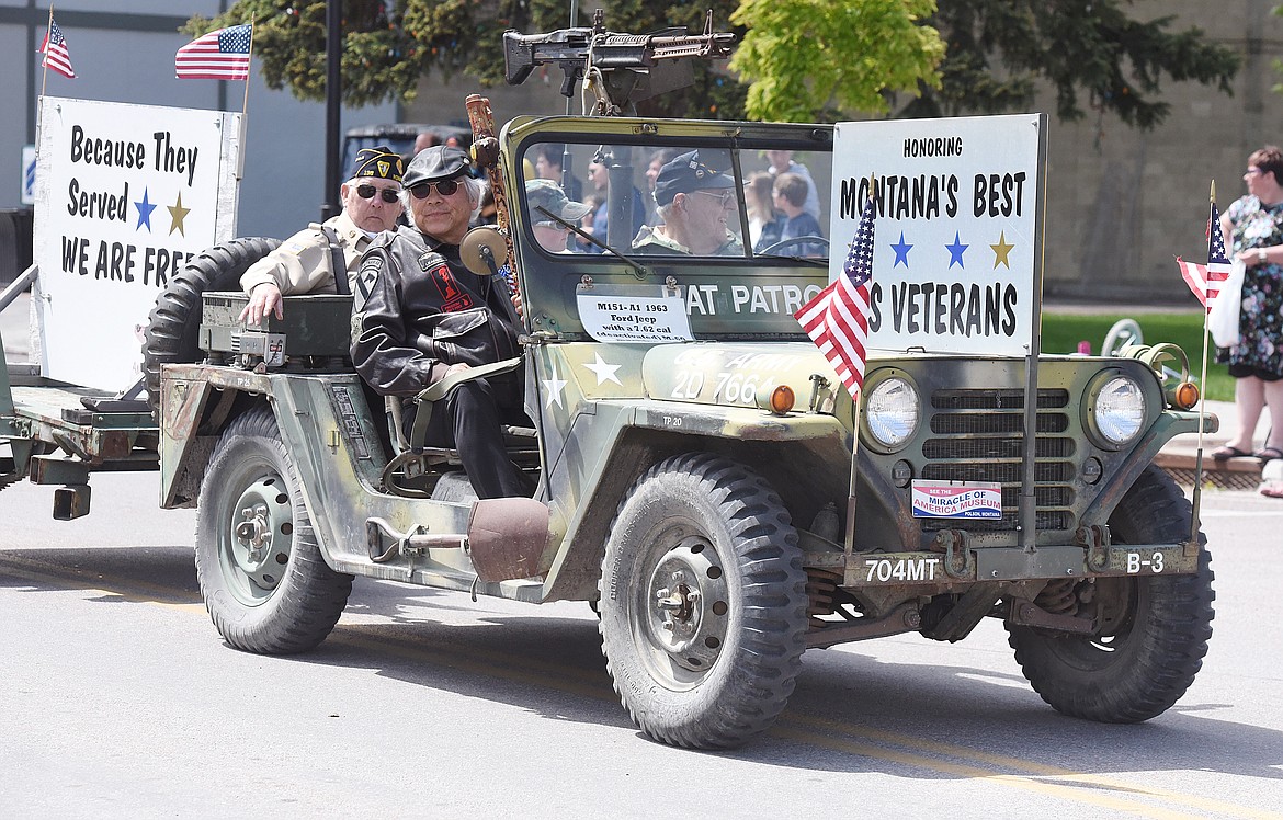 THE SIGNS on this Army jeep in the Polson parade speaks well for all U.S. veterans, living and deceased, who fought for our freedom. &#147;United they stood and united they sacrified&#148; was the lead statement in the Memorial Day ceremony at the Ronan cemetery. Henry Peiper is the driver. His passengers include Ed Cornelius, Colton Pieper and an unidentified man. The Jeep resides at the Miracle of America Museum on the south edge of Polson.