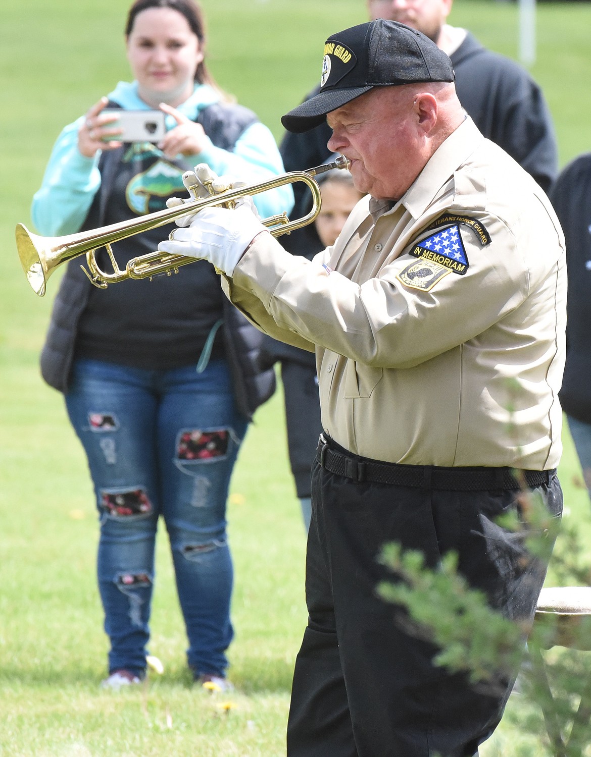 JERRY AKERS of the Veterans Honor Guard plays Taps during the Memorial Day ceremony in Polson.