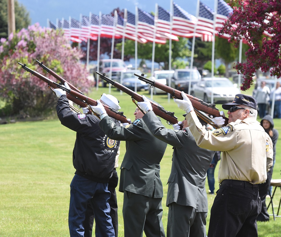 VETERANS RIFLE squad members fire their weapons during a salute to our fallen heroes at the Memorial Day ceremony at Lakeview Cemetery in Polson.