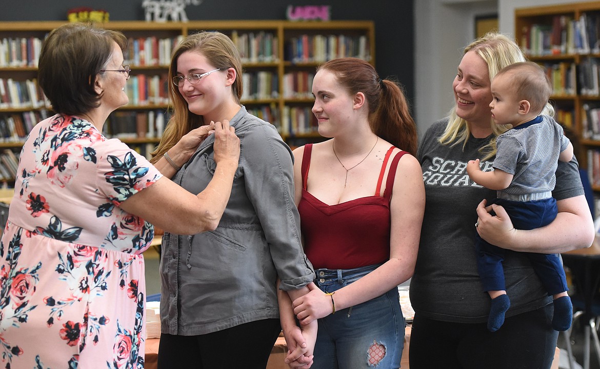 NATALIE WORKMAN receives her CNA program graduation pin from instructor Lorraine Frost, RN. Watching the pinning are, from left, Natalie&#146;s sister Katherine Workman, mother Diamond Courville and nephew Liam Slocum. (Joe Sova photos/Lake County Leader)