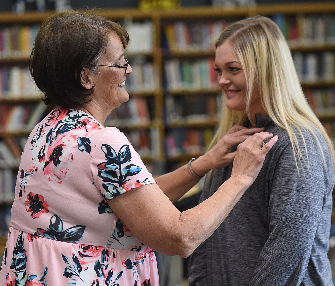 TORI PALMER receives her CNA program graduation pin from instructor Lorraine Frost, RN.