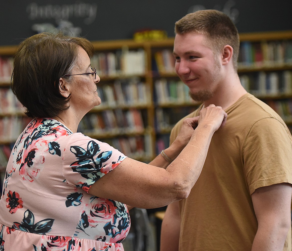 DADEN COLLICOTT is pinned by instructor Lorr-aine Frost, RN, during the Ronan High School CNA program graduation ceremony.