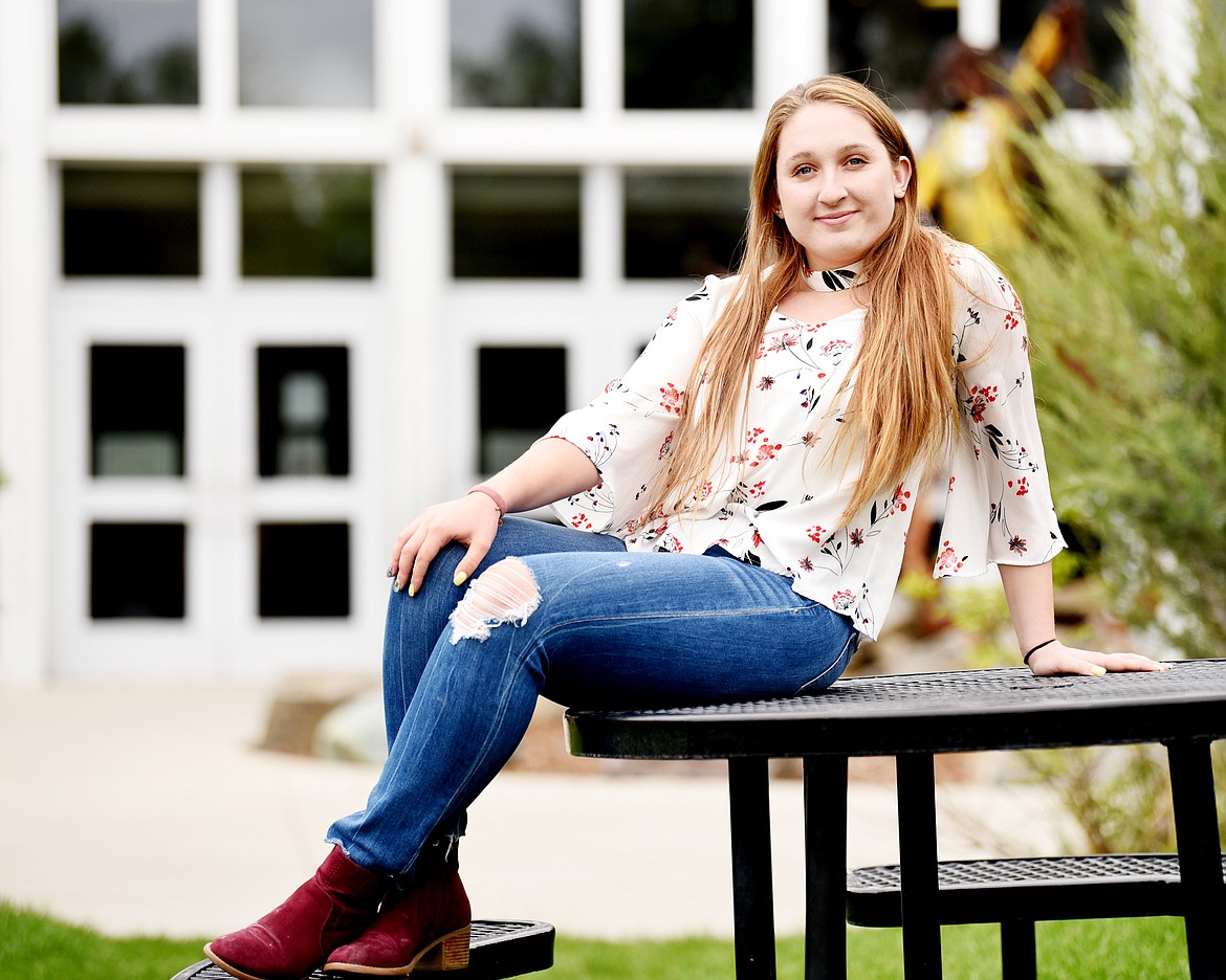 Payton Hallos sits on a bench in front of Flathead High School on Monday, May 20. Hallos is a volunteer with Special Olympics and the United Way&#146;s Lunch Pail Pals program at Elrod Elementary. She is also a National Honor Society member and an executive Ignite mentor. (Brenda Ahearn/Daily Inter Lake)