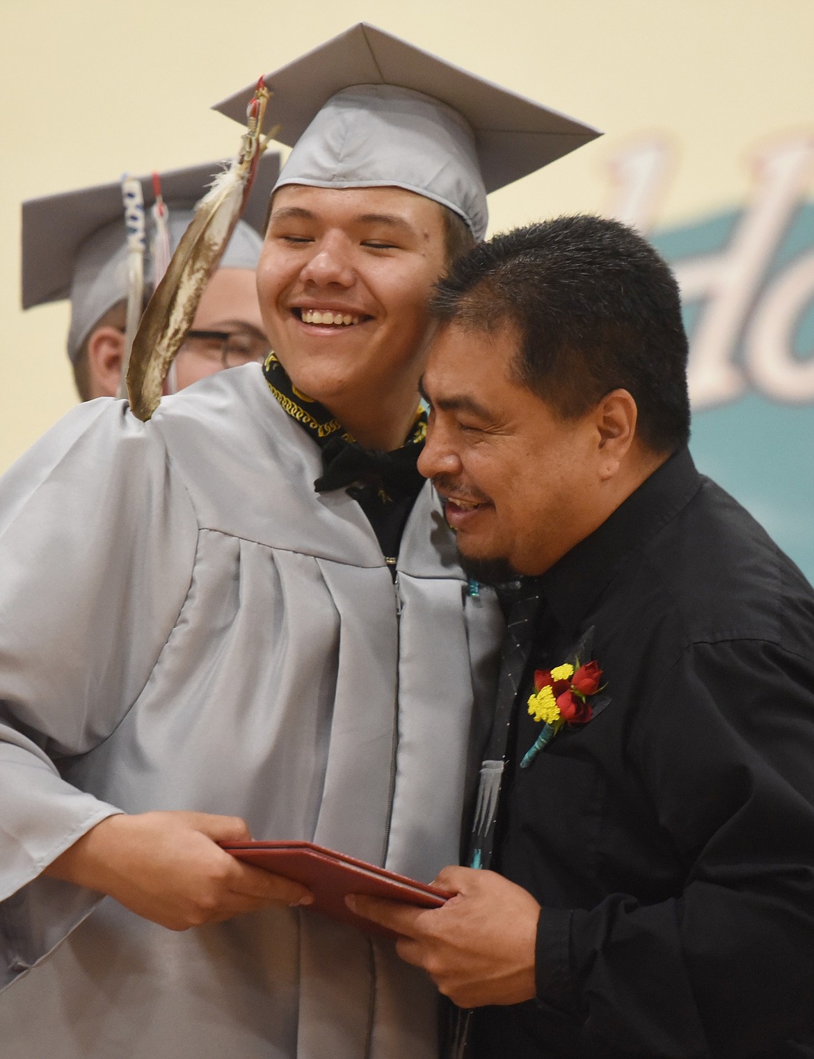 TWO EAGLE River School Board chair Leroy Black gets a hug from Kesean Burke. (Joe Sova photos/Lake County Leader)