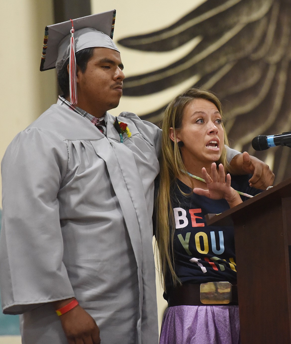 ABOVE, TWO Eagle River School staffer Annie McDonald tells a story about graduate Justice Bourdon-Pichette during graduation.