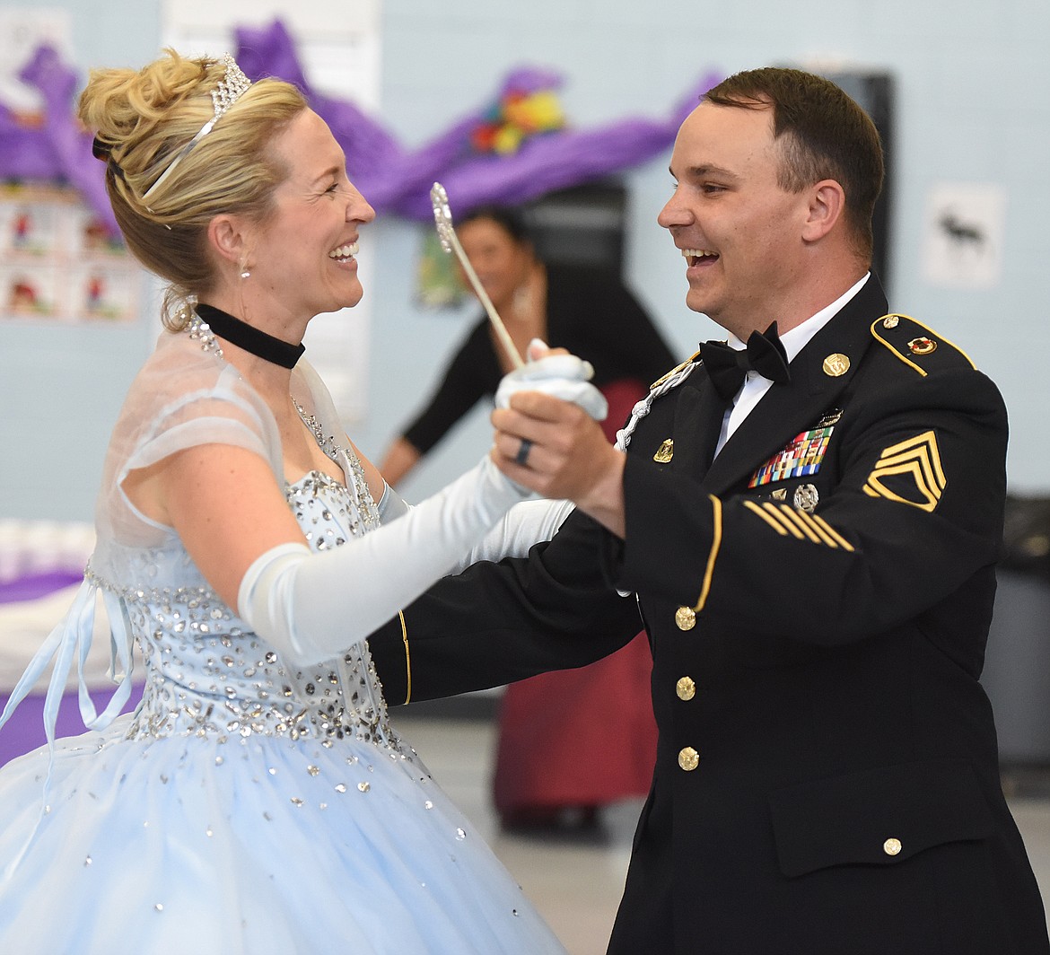 CINDERELLA (school counselor Teresa Hanson) dances with Prince Charming (Kevin Hanson) to wrap up &#147;Cinderella&#146;s Ball&#148; last Friday, May 24. It was a special event for first-grade students. The Hansons are real-life husband and wife. Kevin has been in the Army National Guard for 16 years, and works full time at the armory in Kalispell. He returned from a 10-month deployment to Afghanistan two months ago, his third tour of duty &#151; to Afghanistan and Iraq.