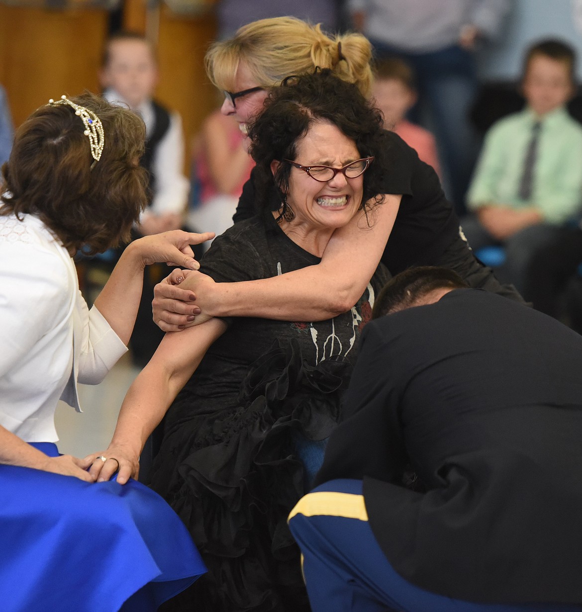 TRY THAT she might, one of the maidens (teacher Joanie Bowen) could not get the slipper found by Prince Charming to fit her foot. Helping with the ordeal are first-grade teacher Joyce Crosby and principal Rhonda Crowl .