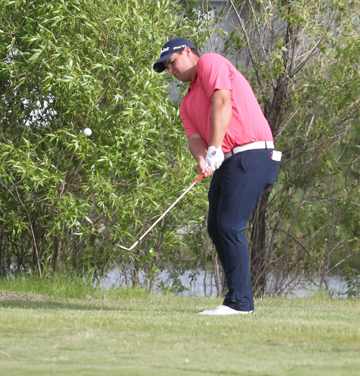 Derek Bayley of Rathdrum chips on the 14th hole Saturday during the third round of the Lilac City Invitational.