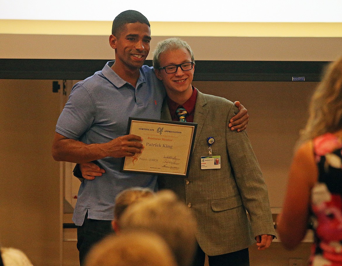 Project SEARCH graduate Jared Bellefeuille snaps a photo with his business mentor, Patrick King, of La Aluminum Casting Company, during graduation Wednesday at Kootenai Health. (LOREN BENOIT/Press)