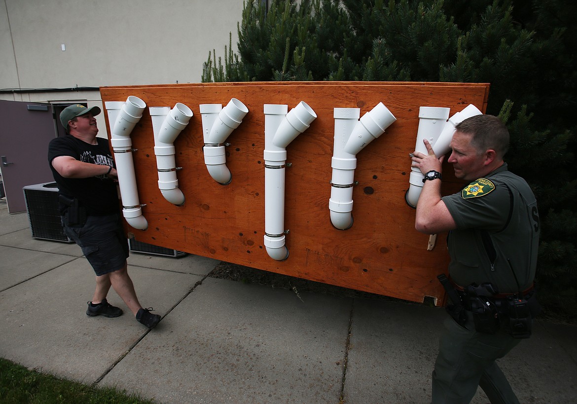 Kootenai County Sheriff Deputies Austin Norris, left, and Jim Dooley help move a new &quot;scent wall&quot; into the Pierce Clegg Building off Dalton Avenue on Wednesday. The new walls will be used by local area law enforcement agencies  (LOREN BENOIT/Press)