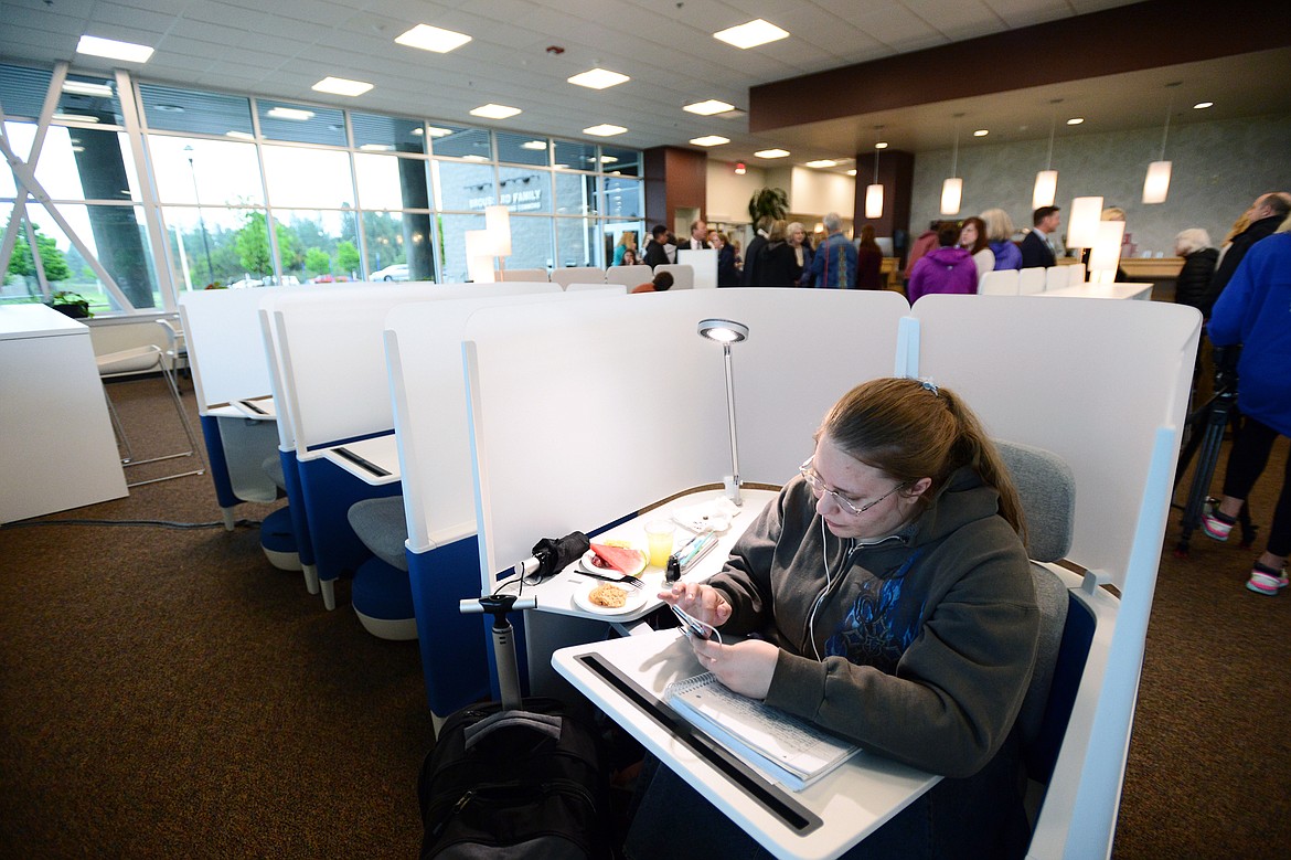 Flathead Valley Community College student Sarah Cloninger studies in a new Brody WorkLounge as visitors tour the Broussard Family Library and Learning Commons after a ribbon-cutting ceremony on Thursday. (Casey Kreider/Daily Inter Lake)