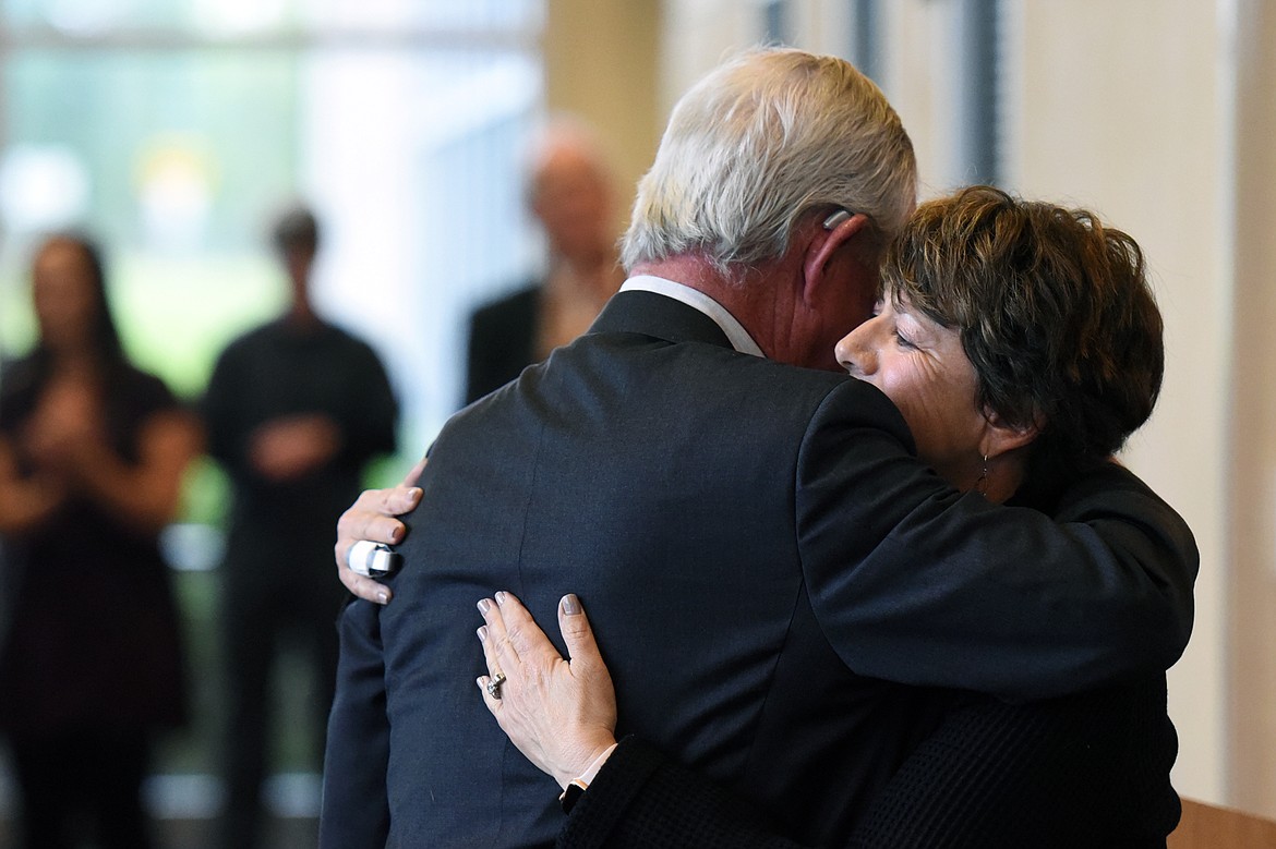 Jerome Broussard and Jane Karas, president of Flathead Valley Community College, embrace before Broussard addressed the crowd gathered before a ribbon-cutting ceremony to unveil the college&#146;s new Broussard Family Library and Learning Commons on Thursday. (Casey Kreider/Daily Inter Lake)