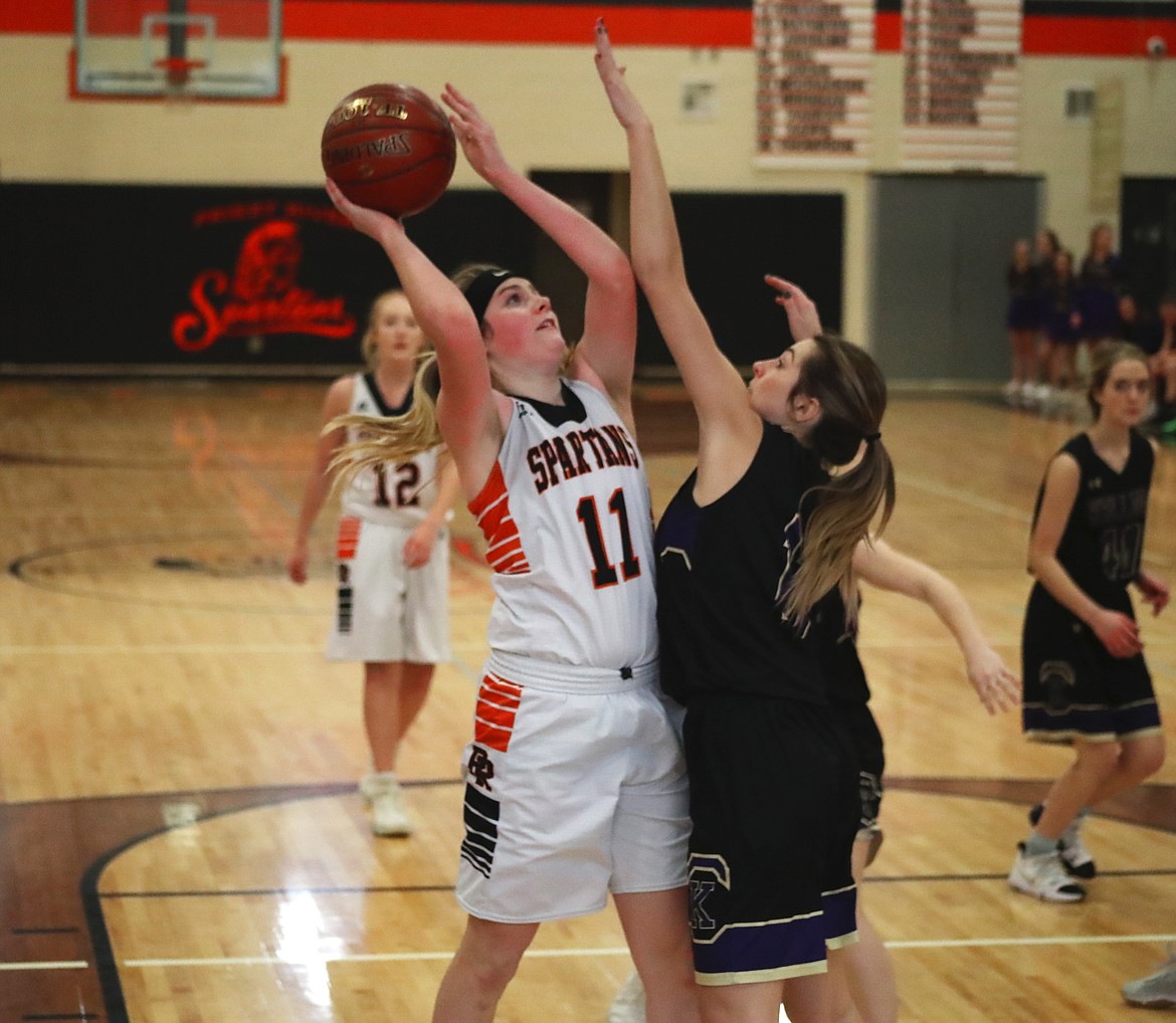 (Photo by KYLE CAJERO)
Priest River junior Karah Fink (left) shoots over a Kellogg defender in the second half of a Jan. 8 game.