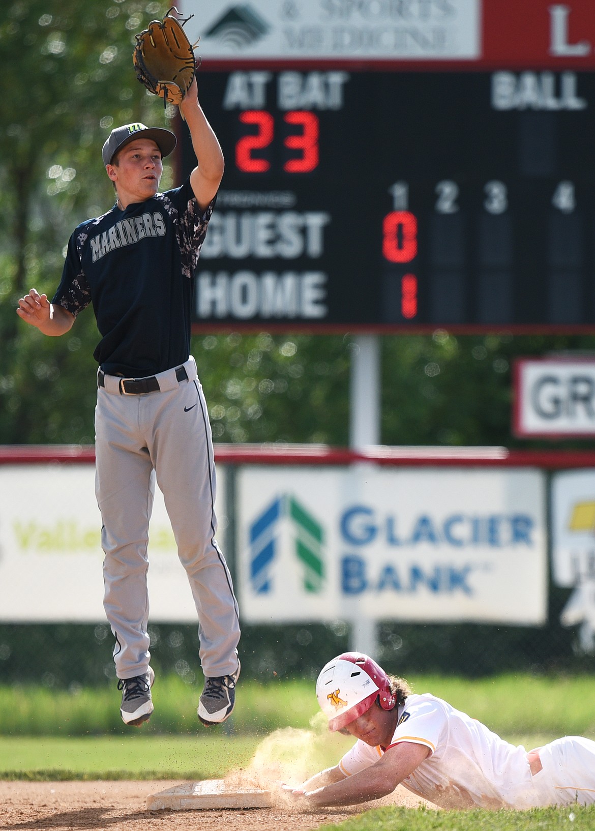 Kalispell's Ryan Symmes steals second base in the bottom of the first against Mission Valley Mariners A at Griffin Field on Wednesday. Taking the throw at second is Mariners' shortstop Xavier Fisher. (Casey Kreider/Daily Inter Lake)