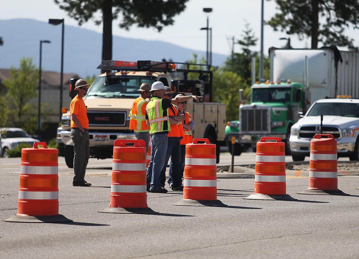 Idaho Transportation Department workers assess the U.S. 95 and Kathleen intersection on Monday after an impaired driver struck one of the light poles early Sunday morning. The driver was arrested. Be prepared to use an alternate route if you re driving east or west on Kathleen Avenue. (LOREN BENOIT/Press)