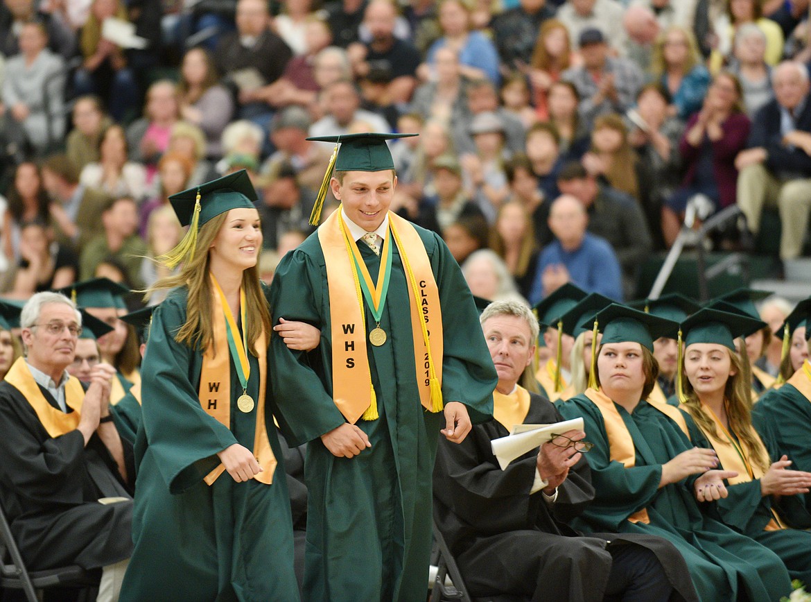 Masters of Ceremony Emily Buckmaster and Jack Schwaiger head to the stage Saturday during the Whitefish High School Class of 2019 graduation ceremony at the gym. (Heidi Desch/Whitefish Pilot)