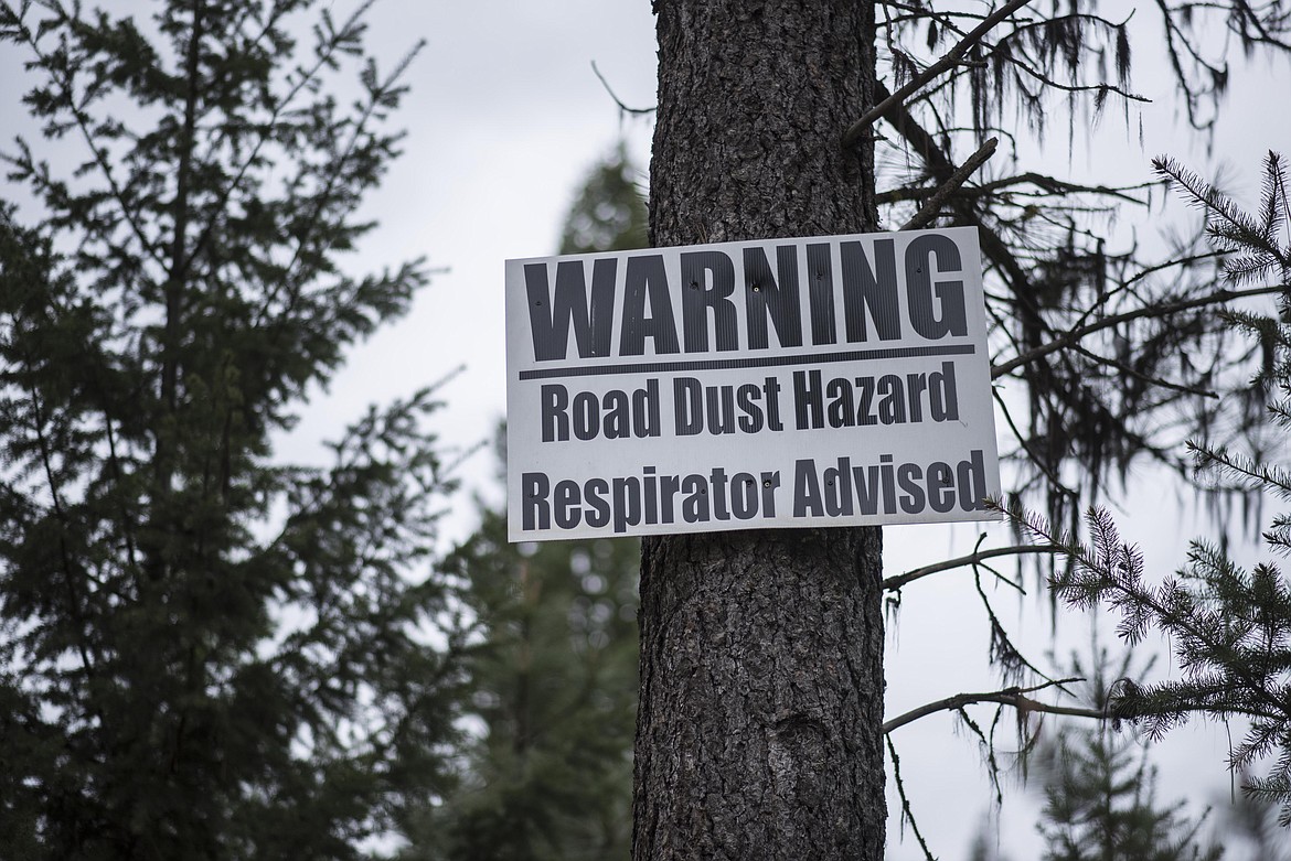 A warning sign nailed to the Panoramic View Estates subdivision road entrance states &#147;Road Dust Hazard Respirator Advised.&#148; (Luke Hollister/The Western News)