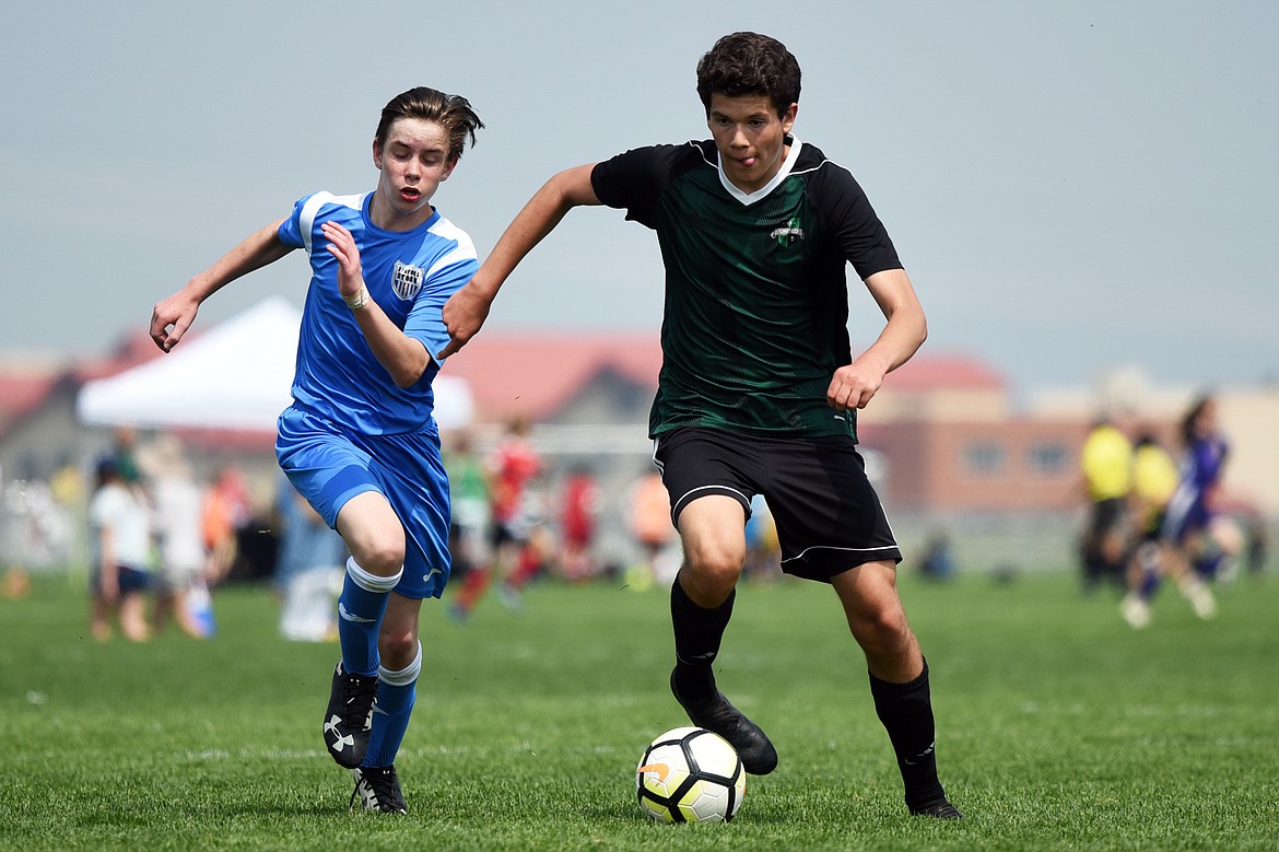 Flathead Valley United Green Benedict's Elijah Mildren, right, dribbles upfield during a boys U16 Pool C game at the Buffalo Wild Wings Three Blind Refs Soccer Tournament on Saturday. (Casey Kreider/Daily Inter Lake)