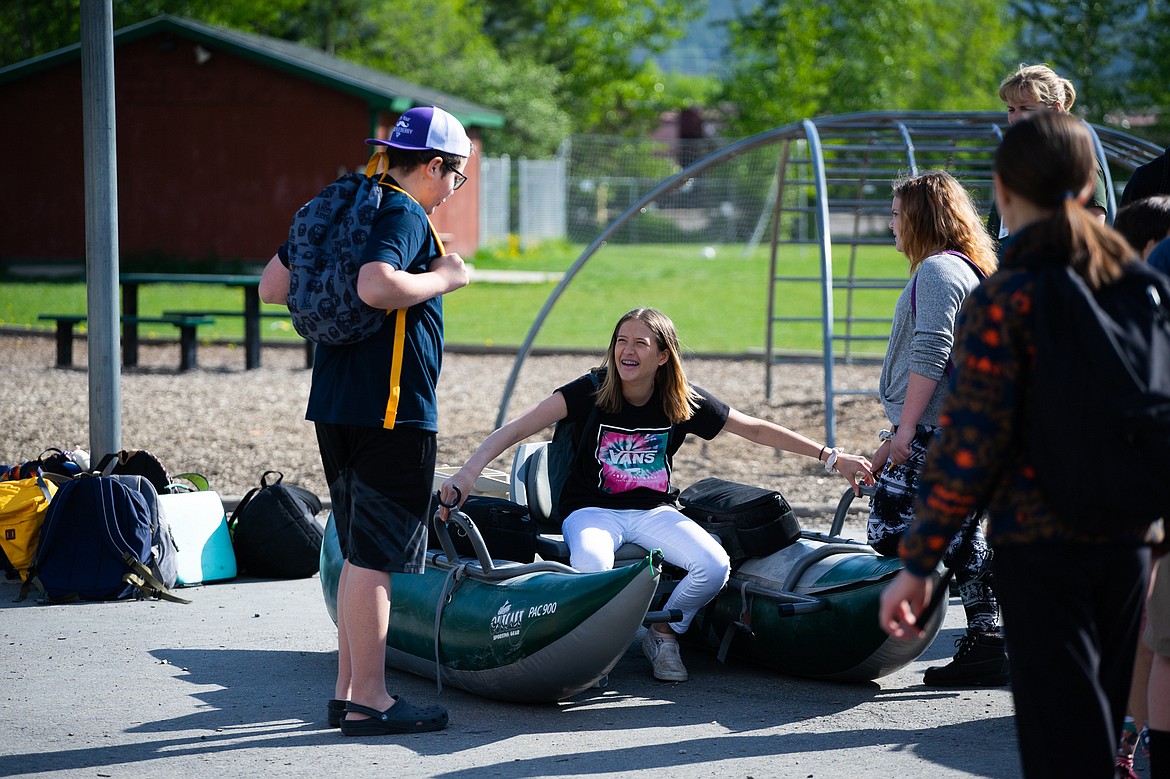 Cole Pickert, Ashby Dominick and Araya Nieves hang out after learning how to inspect watercraft during the Mussel Walk last week. (Daniel McKay/Whitefish Pilot)