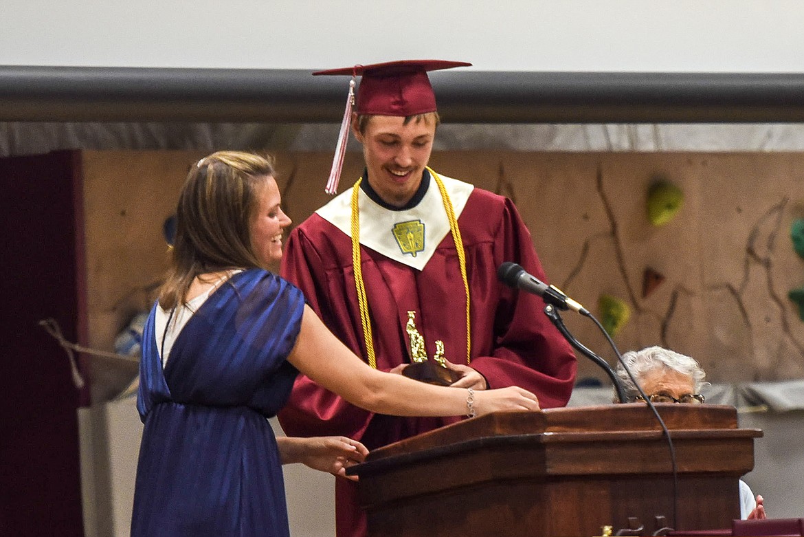 Troy High School valedictorian Dylan Cummings is presented by Troy High School Principal Christina Schertel, Saturday at Troy&#146;s graduation. (Ben Kibbey/The Western News)