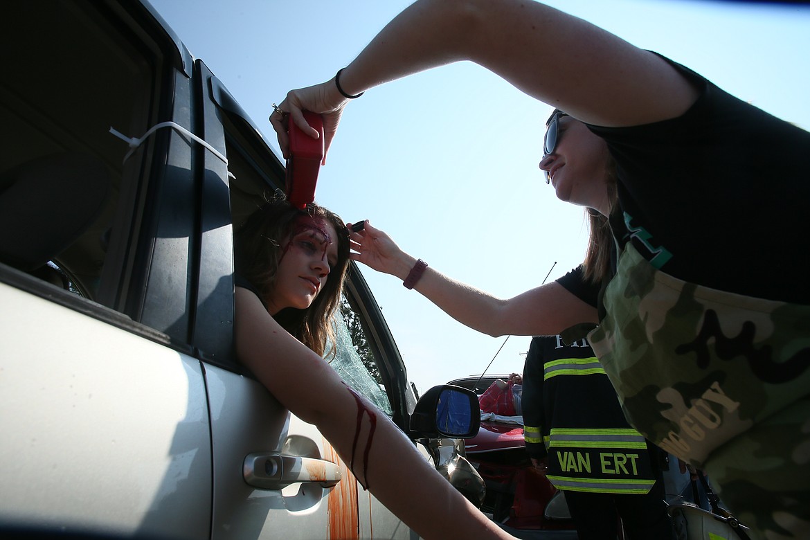 Lakeland High School drama teacher Allison Knoll applies colored corn syrup to Jordan Cooley&#146;s forehead on Friday morning before the simulated DUI fatality at the school.