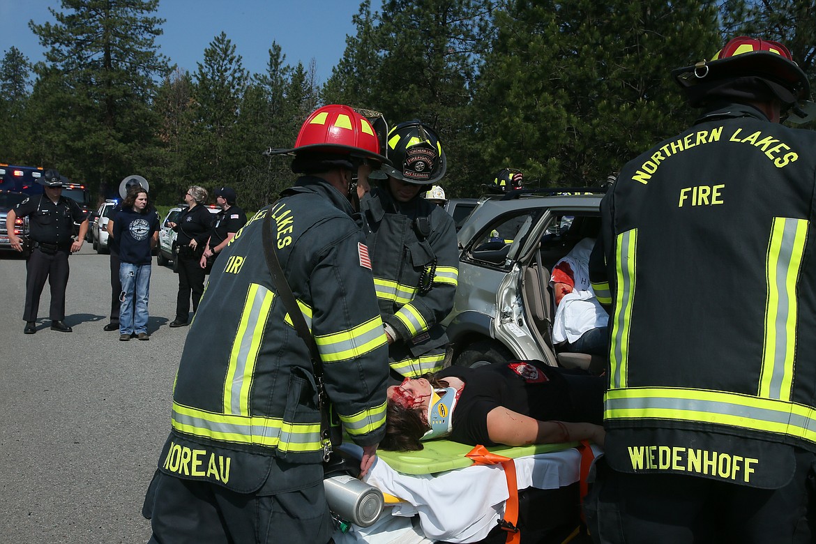 DEVIN WEEKS/Press
Lakeland High School senior Jordan Cooley is placed on a gurney by Northern Lakes Fire personnel as Jaden Jeffries, the simulated drunk driver, is &quot;arrested&quot; by Idaho State Police troopers during the mock DUI crash Friday morning.