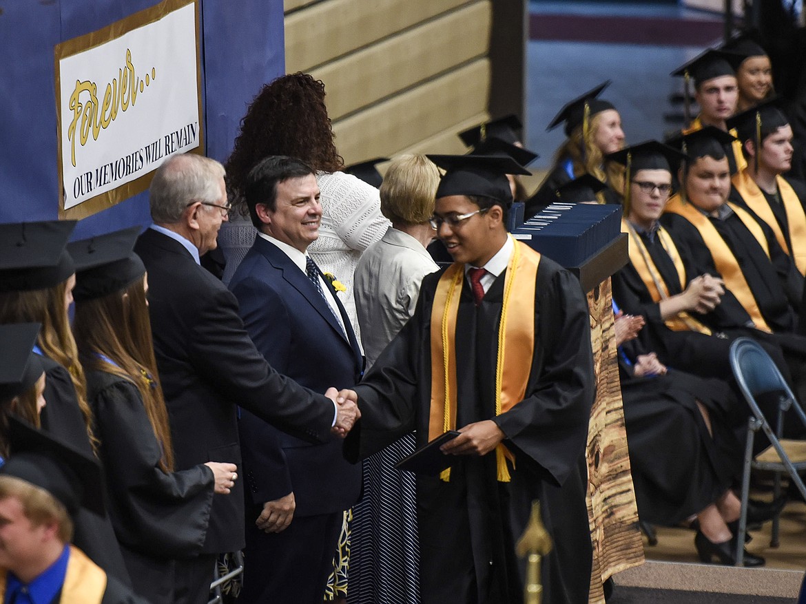 Libby High School&#146;s Elijah Gilliam-Smith is congratulated by commencement speaker Roe Hatlen, Saturday at Libby&#146;s graduation. (Ben Kibbey/The Western News)