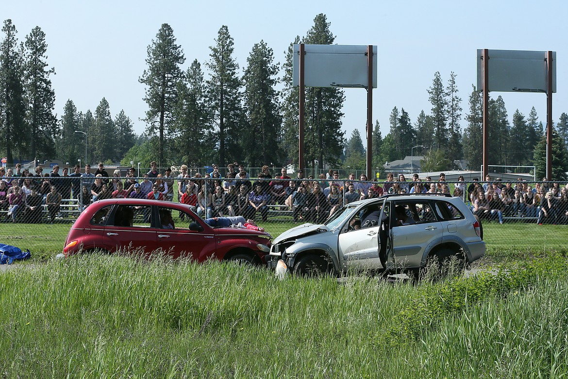 DEVIN WEEKS/Press
Two smashed cars with simulated injured teens trapped inside and one simulated deceased teen on the hood paint a grim picture of DUI fatality reality for Lakeland High School seniors.