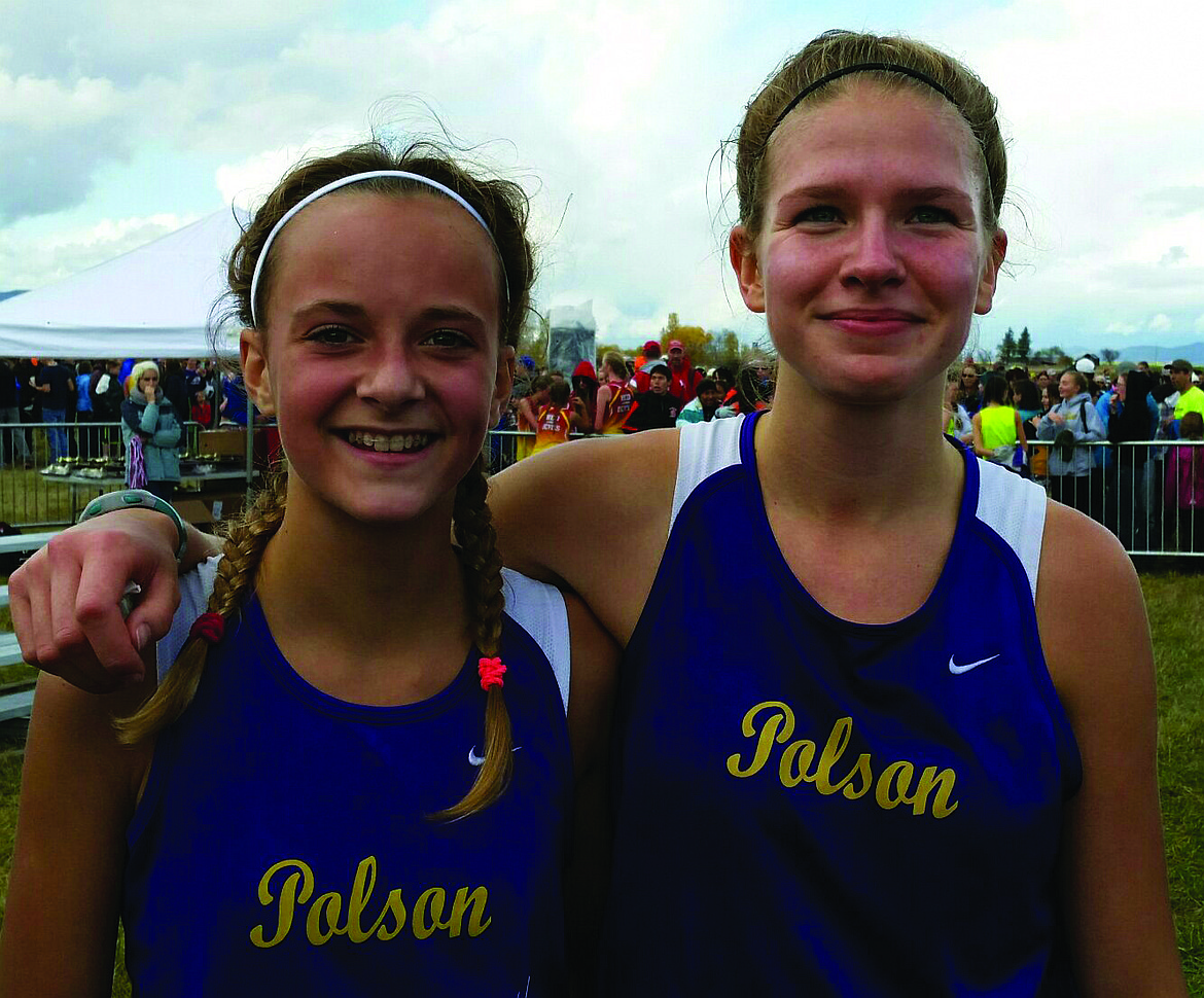 Bea Frissell (right) along with Molly Sitter (left) celebrate with each other during the start of Frissell&#146;s sophomore season at Polson High School. Frissell finished her career by setting two personal records both good enough to win the 1,600-meter run, and the 3,200-meter race at the Class A state high school track meet at Laurel Sports Complex at Laurel High School. (Lake County Leader file photo)