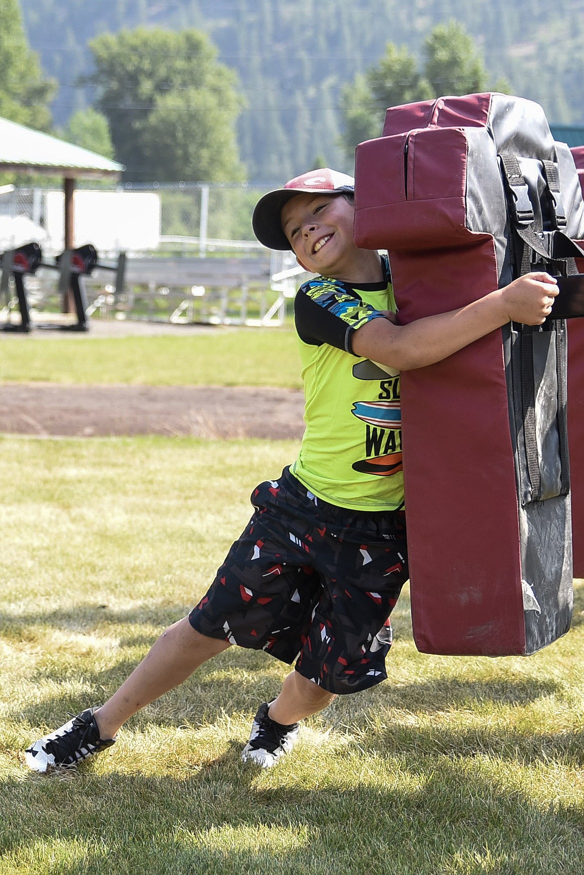 Mason Crowe hits the tackle sled during the Tomorrow&#146;s Trojans youth football camp Saturday, hosted by the Troy High School football team. (Ben Kibbey/The Western News)