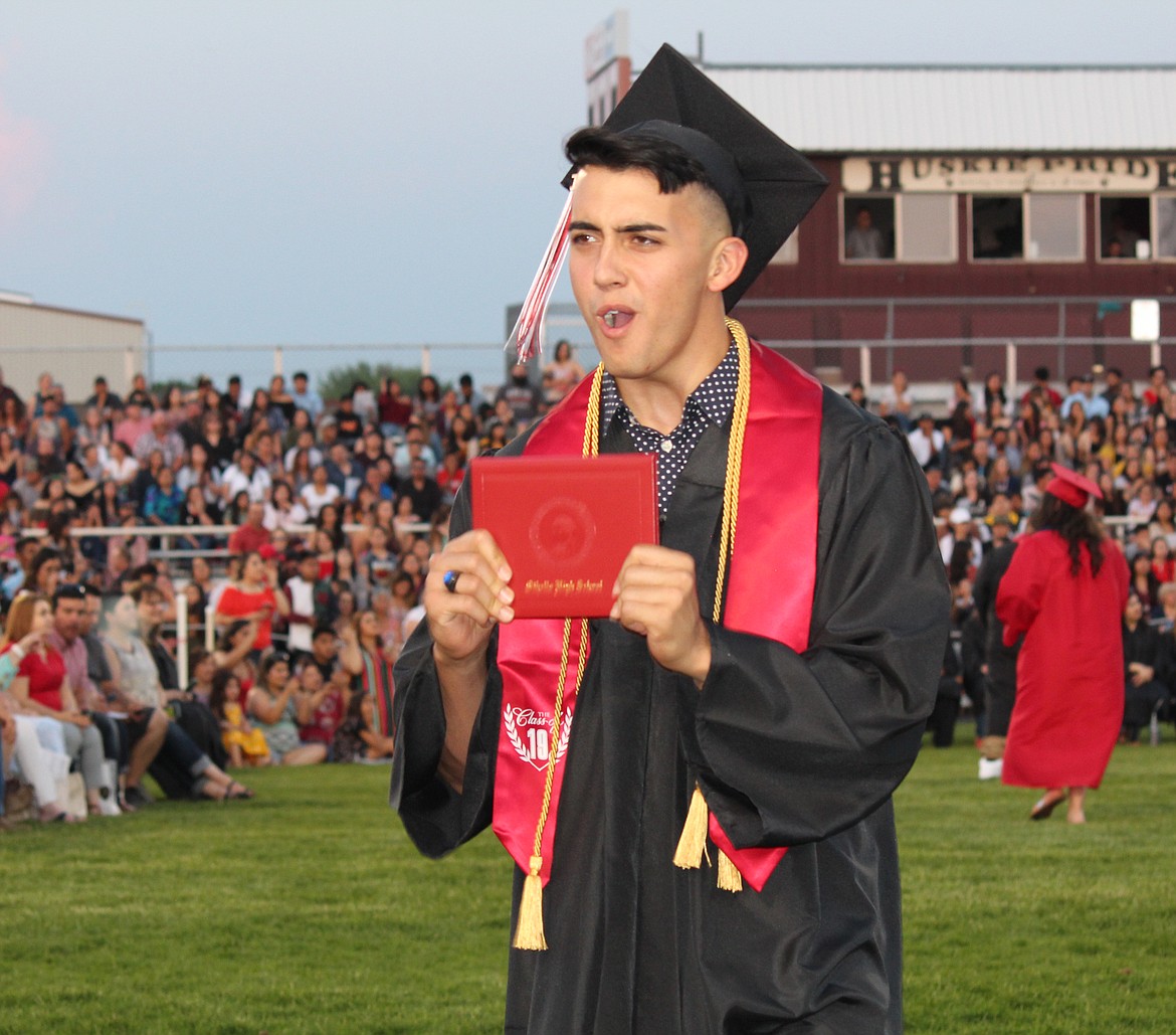 Cheryl Schweizer/Sun Tribune
An Othello graduate stops long enough to let his parents get a picture during Friday&#146;s ceremony.