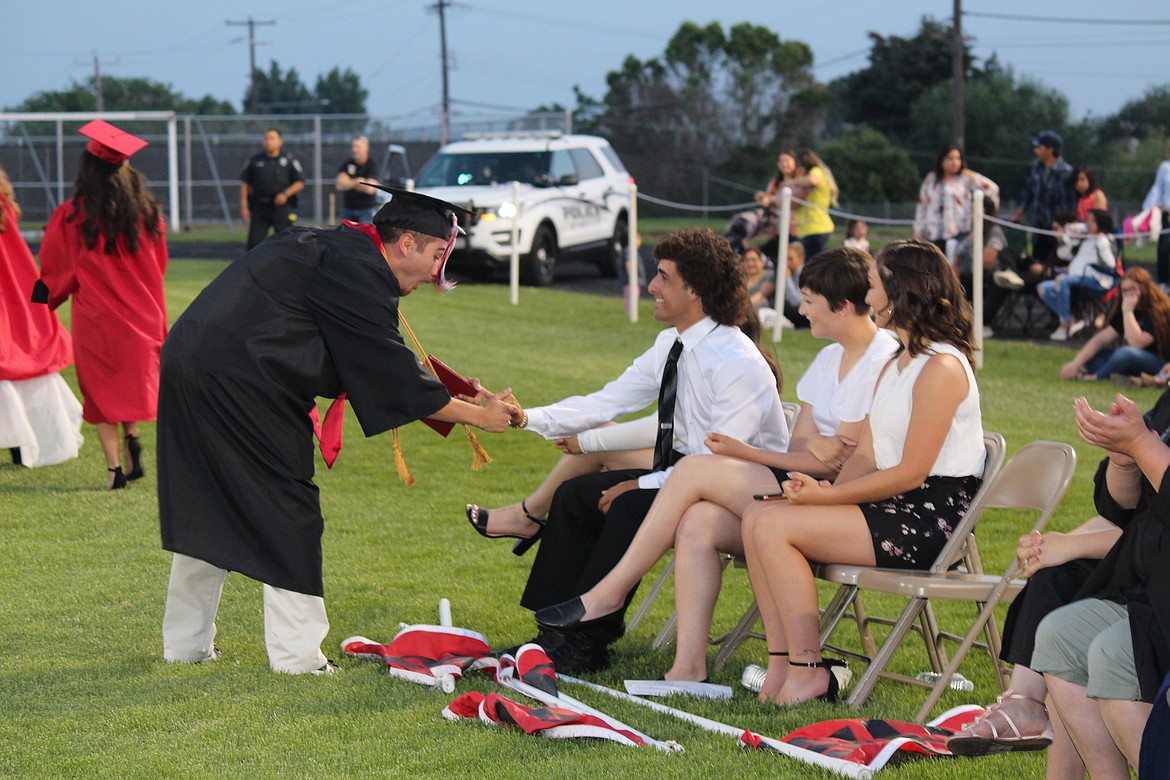 Cheryl Schweizer/Sun Tribune
A 2019 Othello graduate shakes hands with a friend.