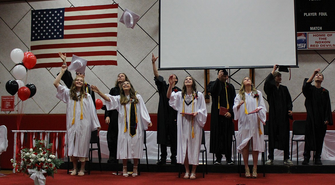 MEMBERS of the Noxon High School Class of 2019 celebrate the acceptance of their diplomas by throwing their caps in the air during the commencement exercise Sunday, May 26. (Photos courtesy of Dana Grupenhoff)