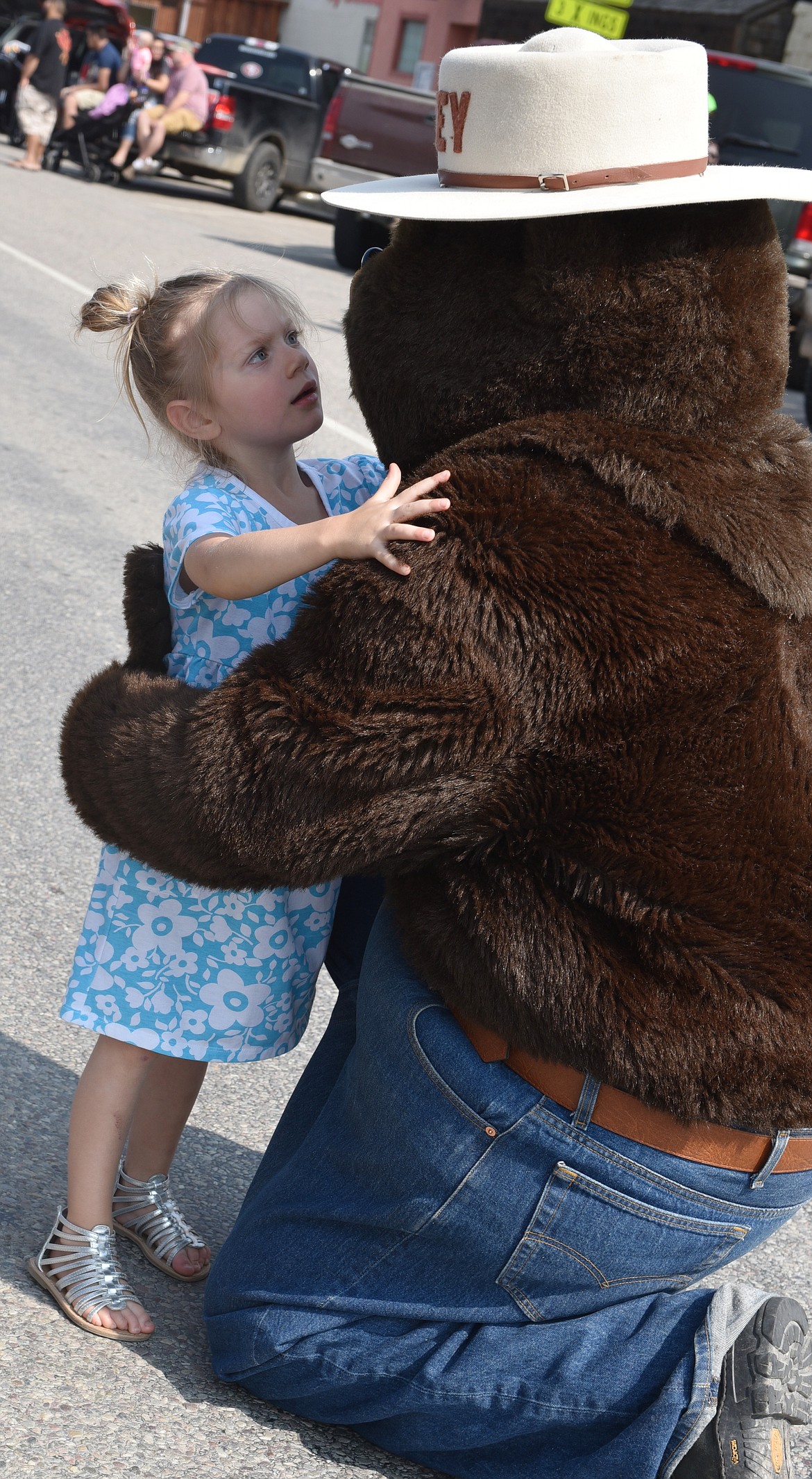 MANY YOUNGSTERS, like the little girl above, ran out and gave Smokey Bear a &#147;bear hug&#148; during the Plains Day Parade on Saturday.