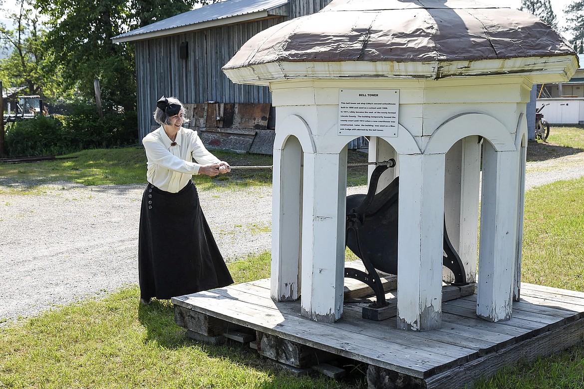 Kathy Powers -- as school teacher Miss Zeigler -- rings the bell to summon her pupils to school at the Heritage Museum’s Opening Day in Libby Saturday. (Ben Kibbey/The Western News)