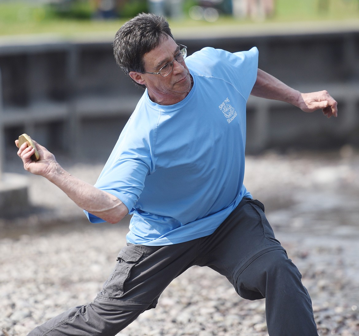 TWO-TIME DEFENDING champion Tom Adrignola tosses a rock along the surface of Flathead Lake on Saturday, June 1. He tied with his brother Carlo for first place in the 13 &amp; over male division.