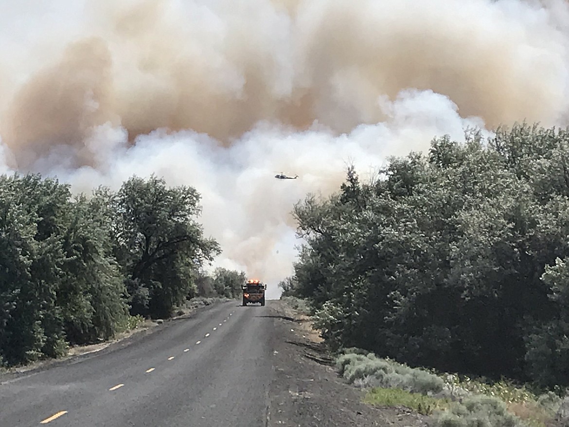 Grant County Sheriff&#146;s Office/courtesy photo
A firetruck and a support helicopter as seen from the fire&#146;s western edge along Lower Crab Creek Road.