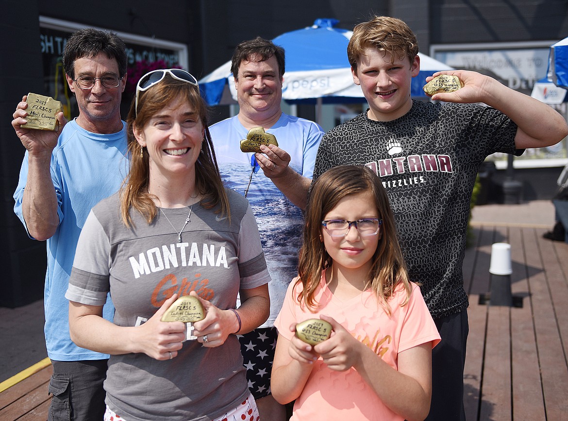 DIVISION WINNERS in the fifth annual Flathead Lake Rock Skipping Championship held Saturday, June 1 were, from left, front row, Katie Walter, female 13 and over; and Arinna Schall, female age 12 &amp; under; and back row, Tom Adrignola and Carlo Adrignola, male age 13 &amp; over (co-champions); and AJ Brown, male 12 &amp; under. The winners show off their championship rocks. (Joe Sova photos/Lake County Leader)