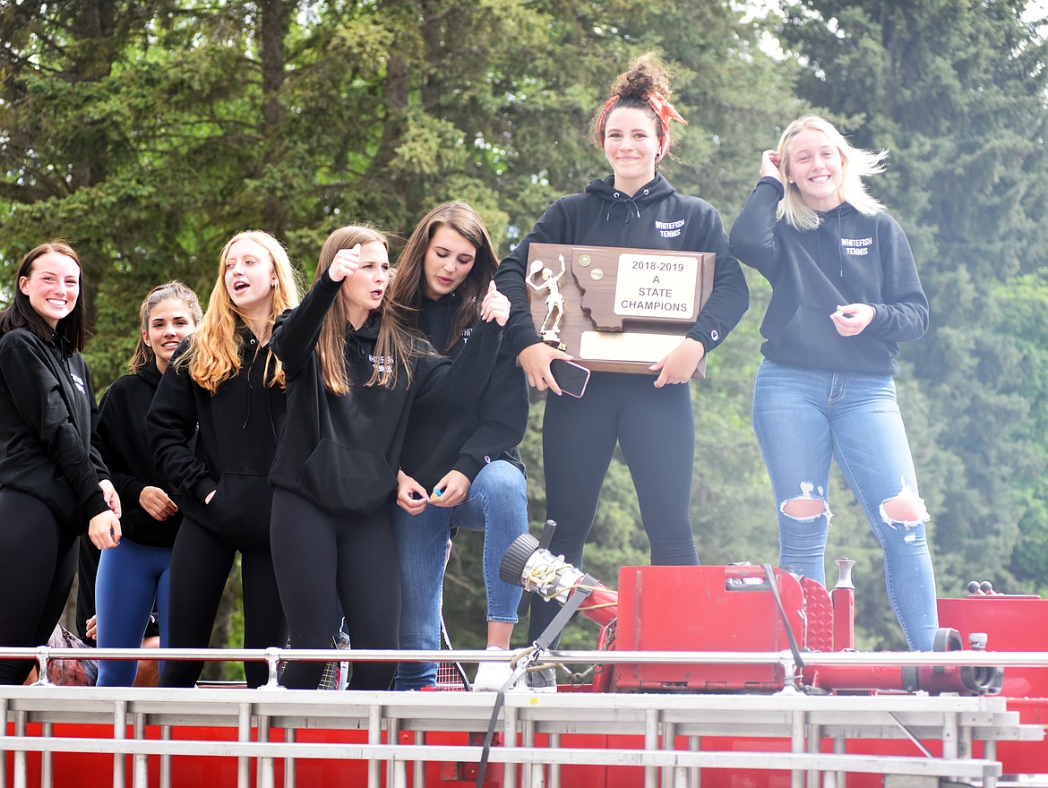 The Whitefish Bulldog girls tennis team takes a victory lap on a Whitefish Fire Department truck to celebrate their Class A state title. (Heidi Desch/Whitefish Pilot)