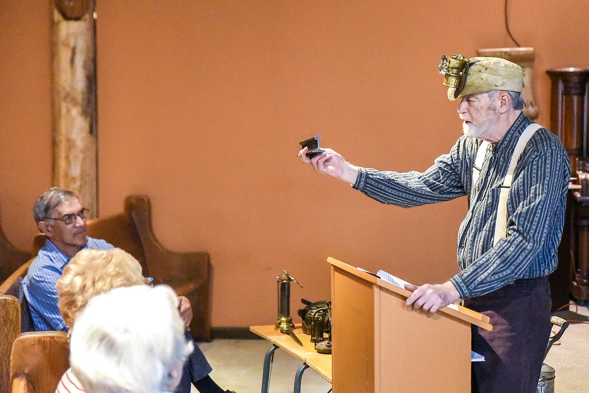 Mike Cohen holds up a piece of 12-pound rail -- named for the weight of a yard of rail -- during a talk on mining heritage at the Heritage Museum&#146;s Opening Day in Libby Saturday. (Ben Kibbey/The Western News)