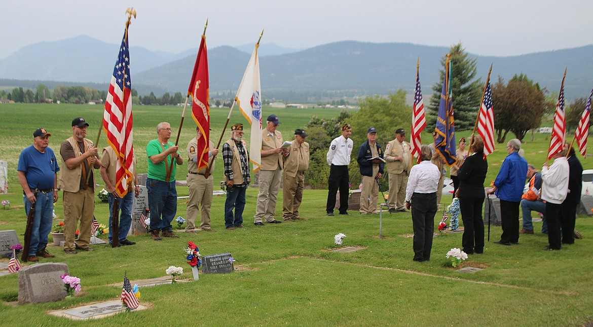 MEMBERS OF the Plains VFW Post 3596 and the Ladies Auxiliary attend the traditional Memorial Day ceremony at Plains Cemetery last Thursday, May 30. Also on that day, Charles Oelschlager handled the traditional dropping of the Memorial Day wreath from the bridge into the Clark Fork River. (Staff photo)