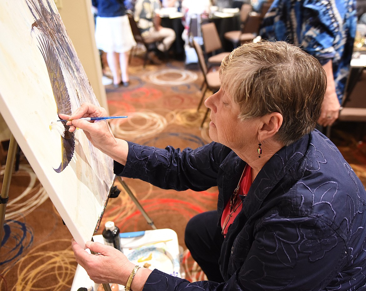 OLIVIA OLSEN uses a steady hand for her mixed medium painting of a soaring eagle, quite fitting for the On Eagle&#146;s Wings event. The finished painting was a live auction offering. Olsen teaches art at MVCA and kindergarten through sixth grade at Valley View Elementary School.