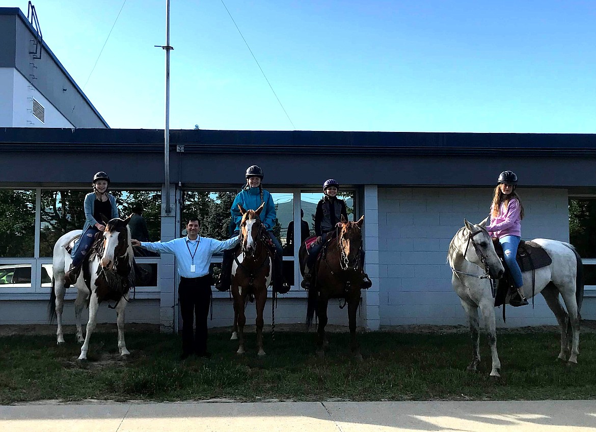 Four Bonners Ferry Middle School seventh-graders rode their horses to school on June 4 ... earning a smile from Principal David Miles.