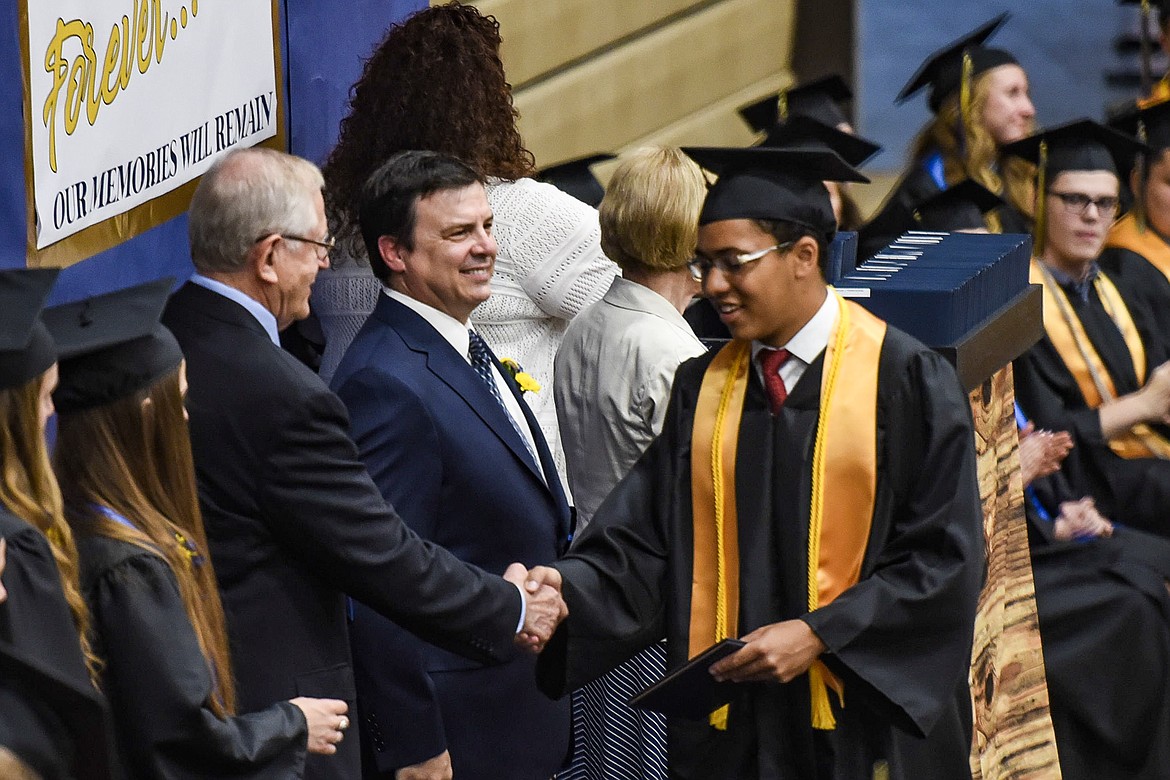 Libby High School&#146;s Elijah Gilliam-Smith is congratulated by commencement speaker Roe Hatlen, Saturday at Libby&#146;s graduation. (Ben Kibbey/The Western News)