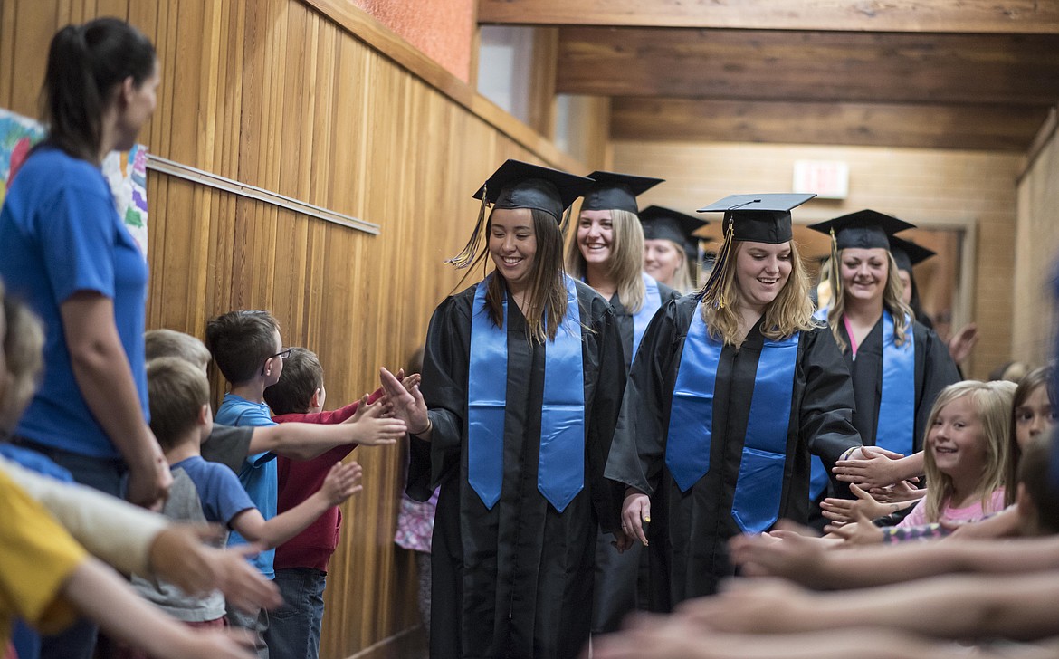 Libby&#146;s graduating seniors walk through the Libby Elementary School halls, cheered on by younger students, Friday. (Luke Hollister/The Western News)