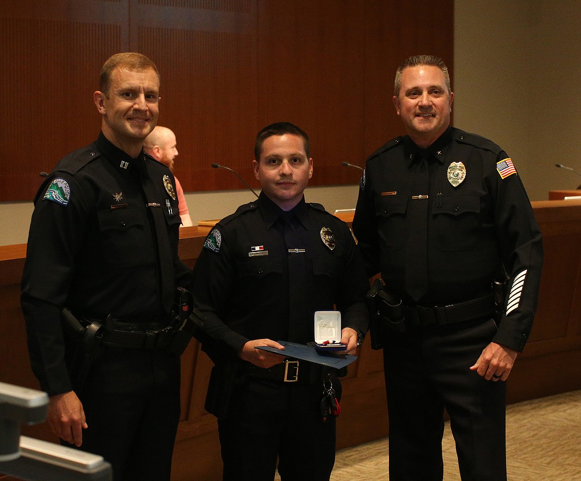 LOREN BENOIT/Press
Officer Chris Christensen, center, also received a Life-Saving Award for his swift actions responding to an unresponsive man last November. Pictured left is Post Falls Police Capt. Jason Mealer. On the right, Chief Pat Knight.