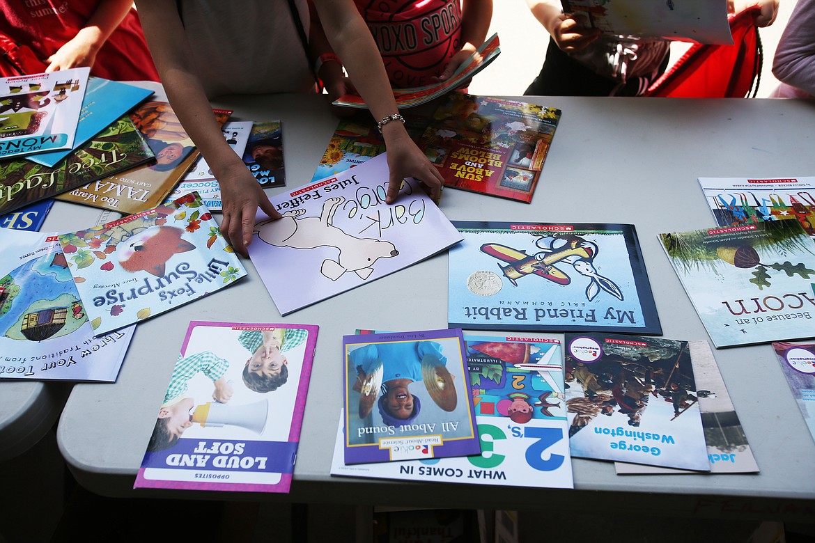 A Coeur d'Alene School District student chooses a &quot;Bark Gorgie&quot; book during Monday's CDA Reads event at  Fernan STEM Academy. (LOREN BENOIT/Press)