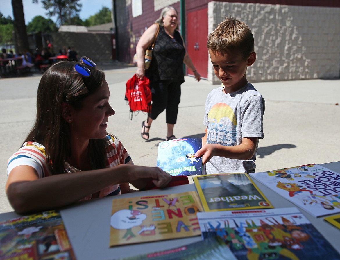 LOREN BENOIT/Press
Camden Nelson shows his mom, Jeni Nelson, his book he picked out during the CDA Reads event Monday at Fernan STEM Academy.